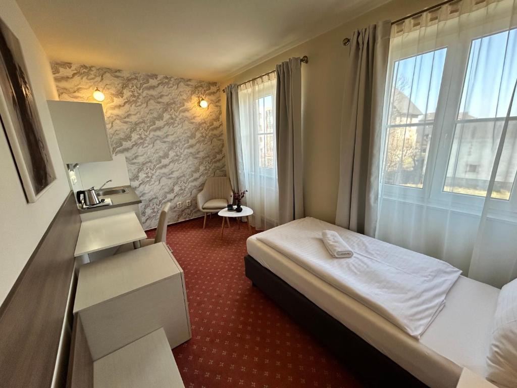 Postel nebo postele na pokoji v ubytování Hotel Brixen
