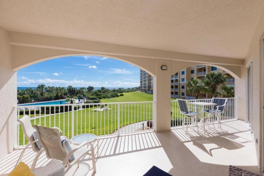 a view from the balcony of a condo with chairs and a table at Surfview 2207 in Palm Coast
