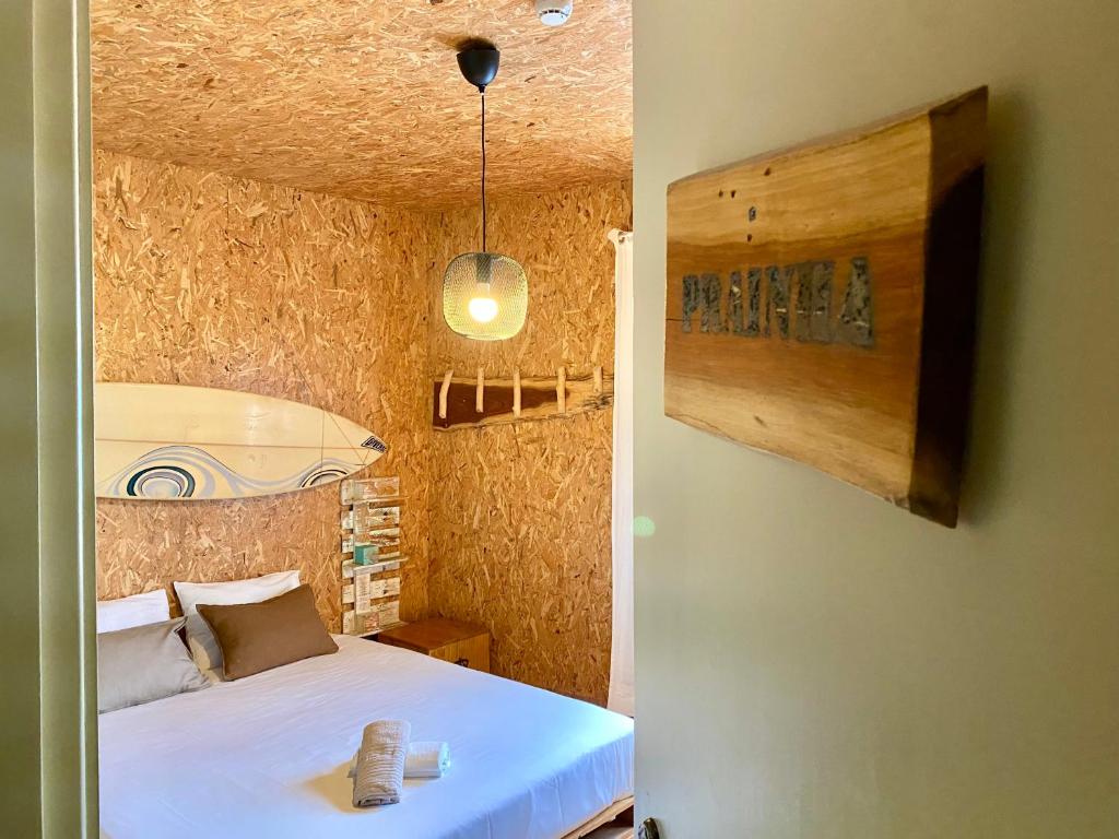 a bedroom with a white bed in a room at Eco Hostel - Tribo da Praia in Ferrel