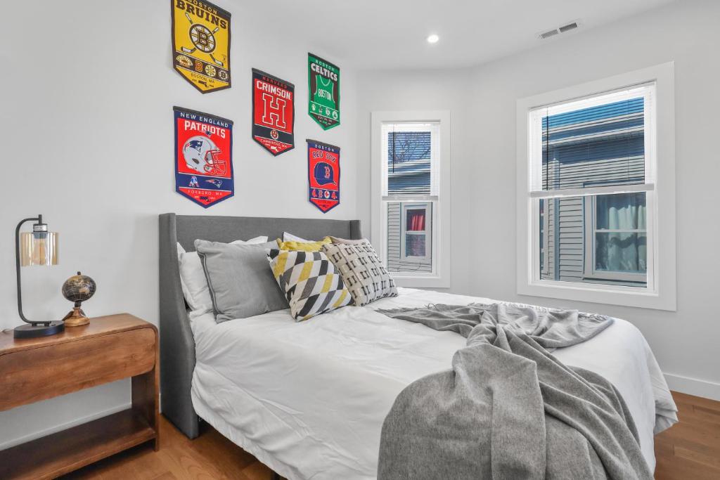a bedroom with a bed with posters on the wall at 3BR2Bth TD Garden,MIT,Harvard,BOS,2 Parking Spaces in Somerville