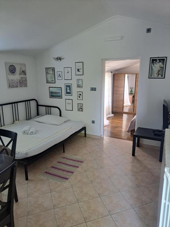 a bedroom with a bed in the middle of a room at Apartman Sweet Home in Palit