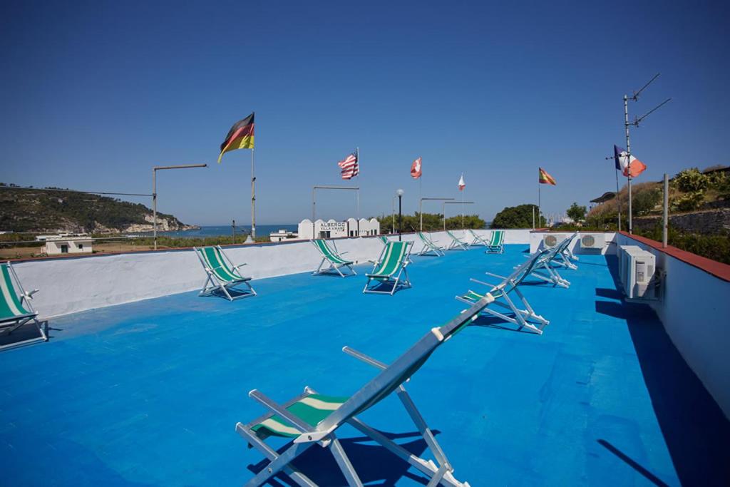 a row of lawn chairs in a swimming pool at Residence & Bed e Breakfast AlaMarina in Peschici