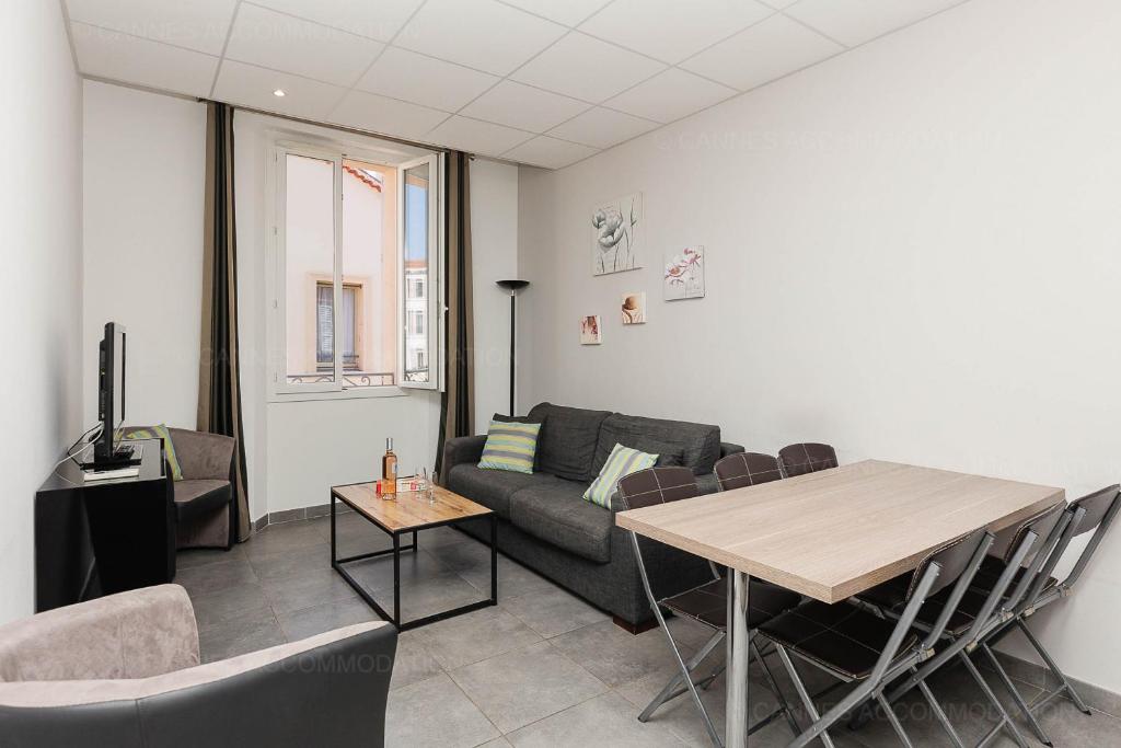 un salon avec un canapé et une table dans l'établissement Residence Aout 31, à Cannes