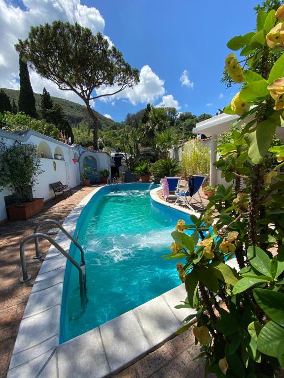 a swimming pool in the backyard of a house at Villa Calù in Casamicciola Terme