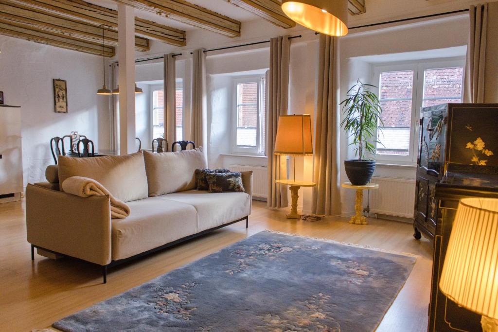 a living room with a couch and a rug at Ferienwohnung Silvia in Villingen-Schwenningen