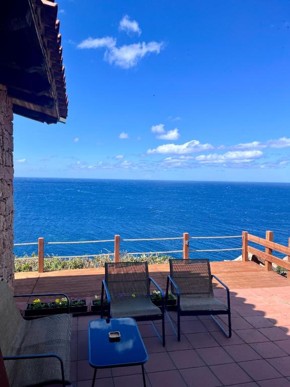 a balcony with two benches and the ocean at Casa Paradiso Guest House in Costa Paradiso