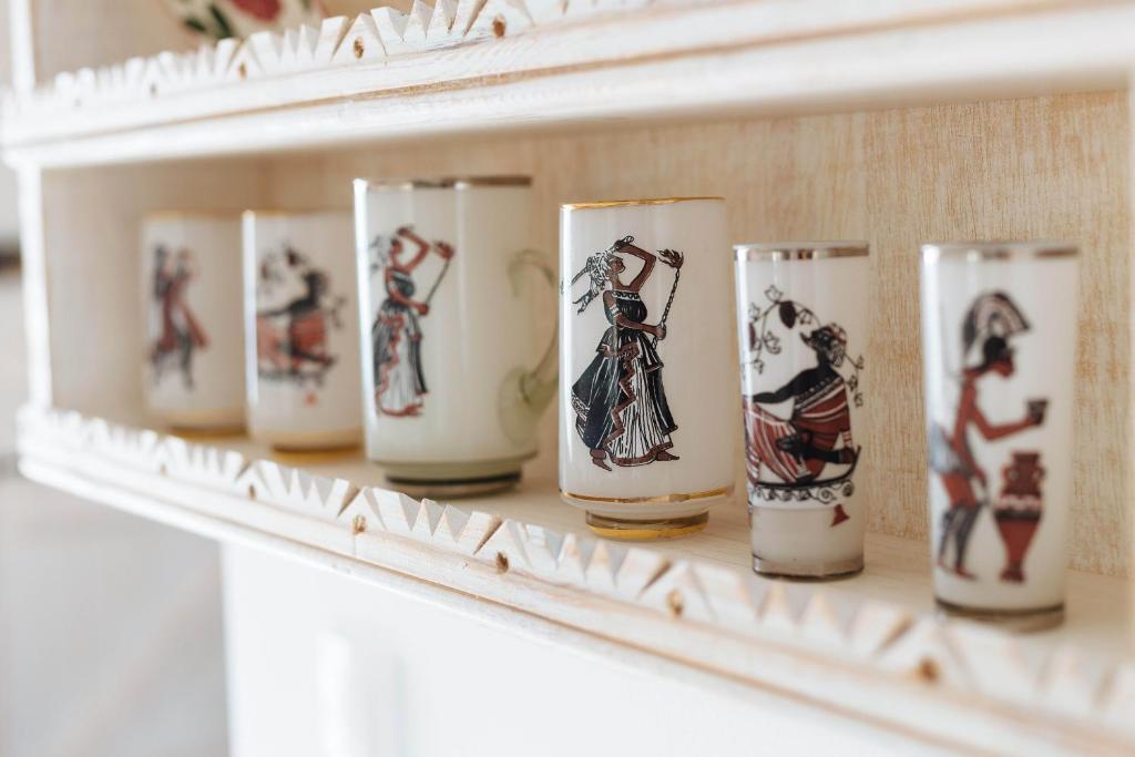 a row of vases sitting on a shelf at Silene Villas in Amoopi