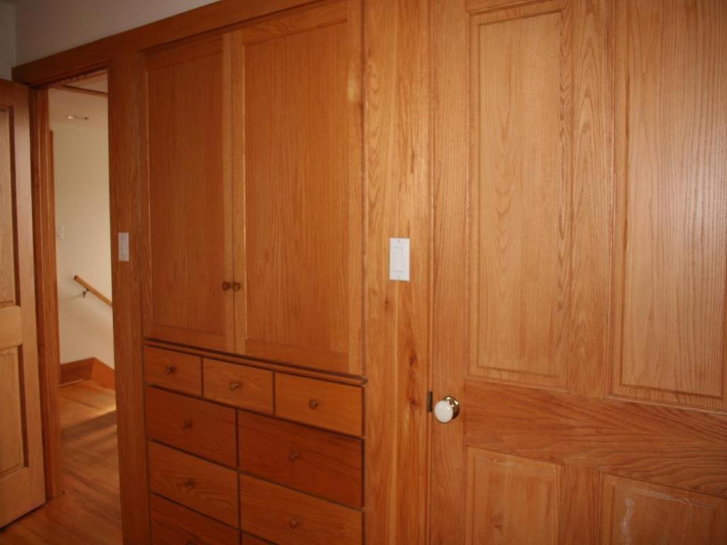 a closet with wooden cabinets and a door at Bay Front Home In Loveladies 44267 in Loveladies