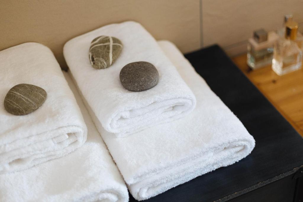 three towels sitting on top of a bathroom counter at Silene Villas in Amoopi