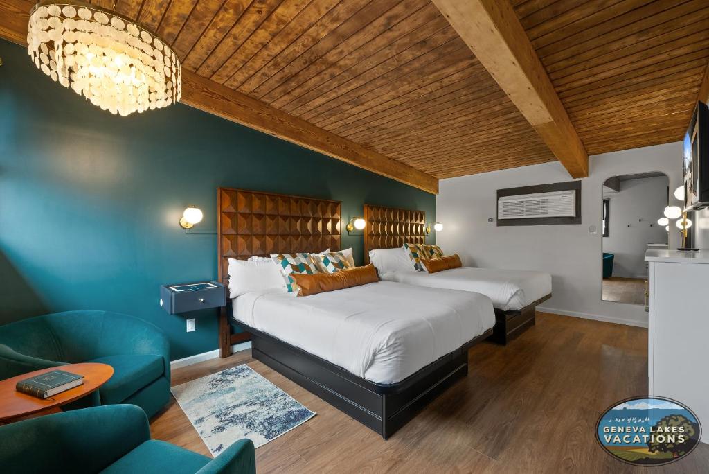 a bedroom with two beds and a couch at The Eastpoint Suite #1 in Lake Geneva