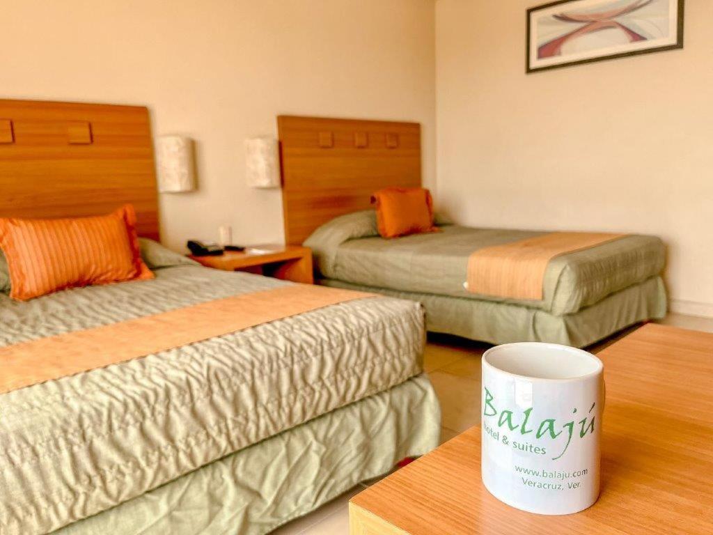 Postel nebo postele na pokoji v ubytování Balaju Hotel & Suites