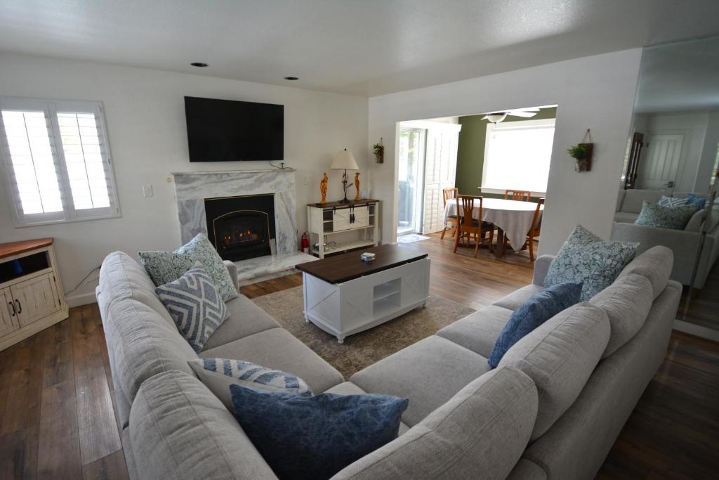 a living room with a couch and a fireplace at Bearadise At North Shore Free Night Special in Bass Lake