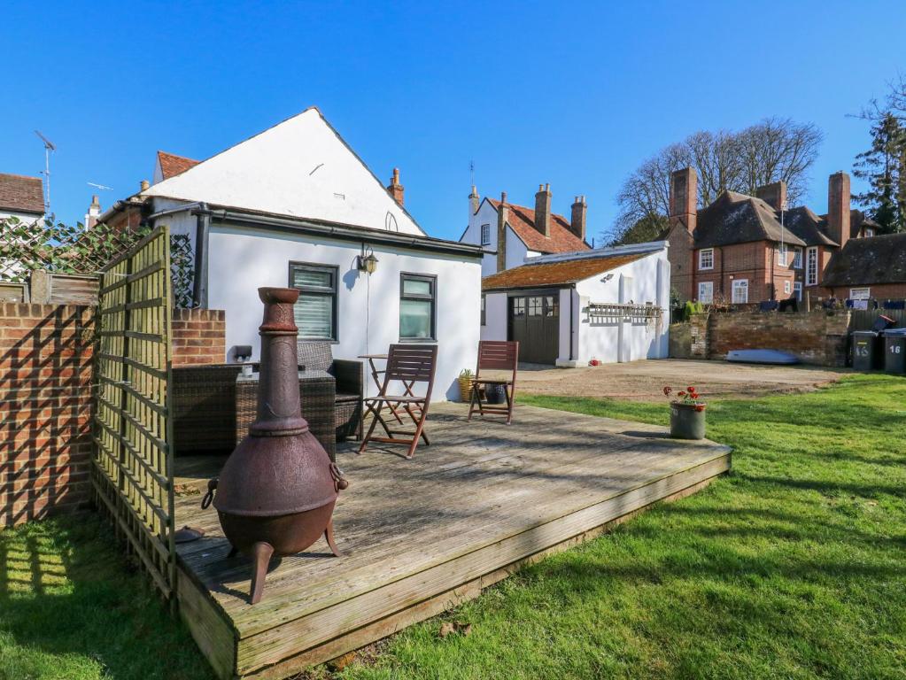 a backyard with a large pot on a wooden deck at The Old Dairy in Herne Bay