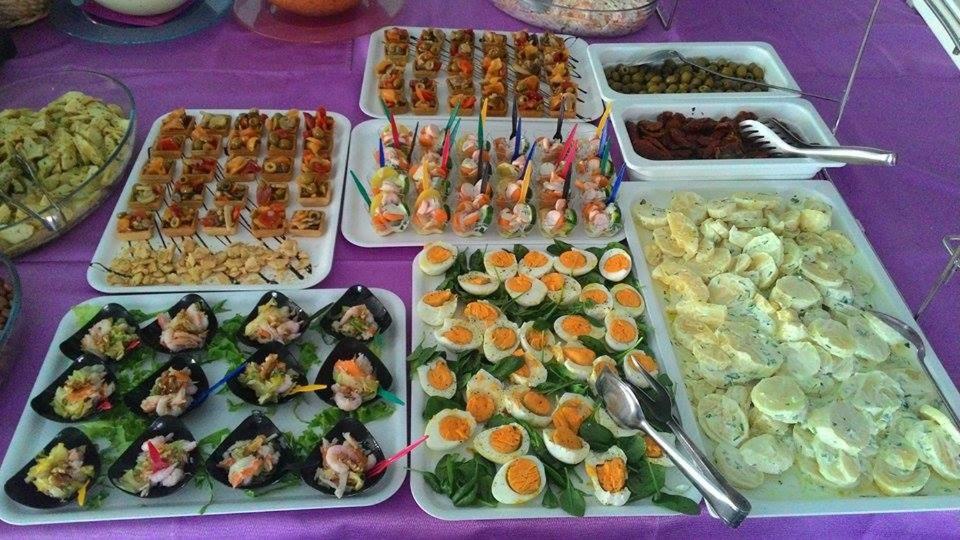 a table topped with trays of food on a purple table at Hotel Maxim in Caorle