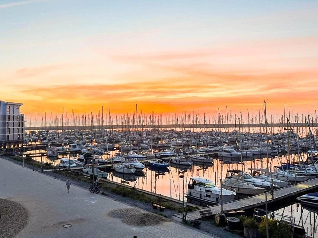 a marina with a bunch of boats in the water at Moderne Wohnung mit direktem Meerblick in Wendtorf