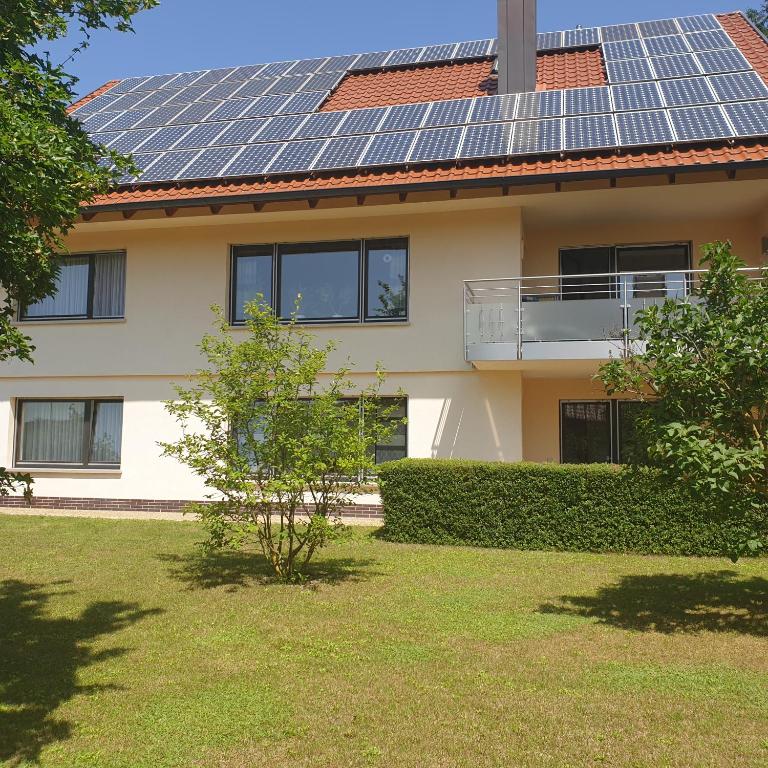 a house with solar panels on the roof at Ferienwohnung Rhönauszeit in Stockheim