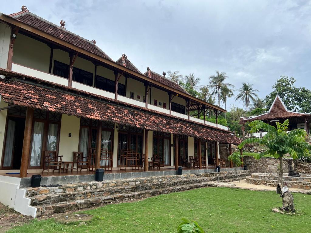 a building with a lawn in front of it at Arys Lagoon Bungalow & Hotel in Karimunjawa