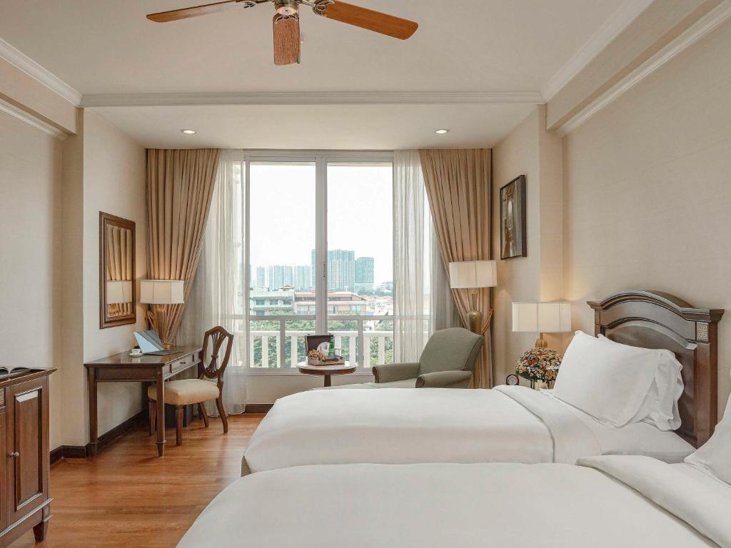 Postel nebo postele na pokoji v ubytování Sofitel Phnom Penh Phokeethra