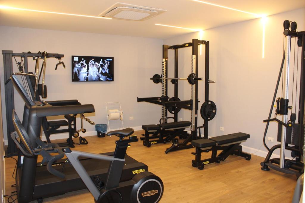 a gym with several treadmills and exercise equipment at Vittoria Parc Hotel in Bari