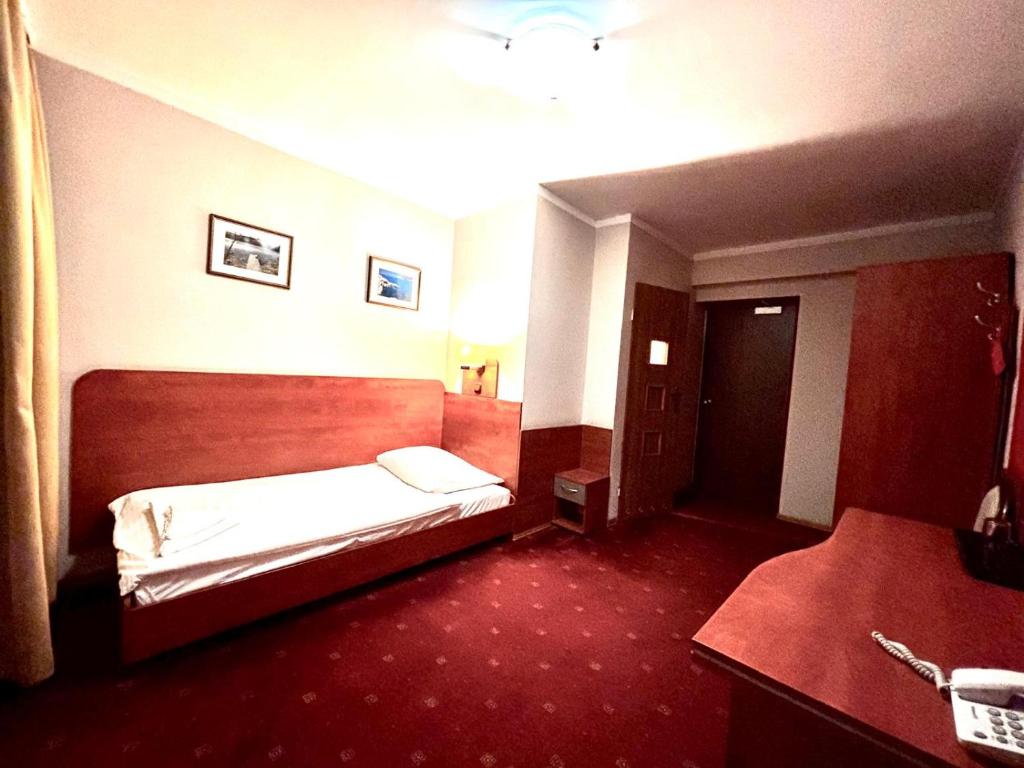 Postel nebo postele na pokoji v ubytování Hotel Orion