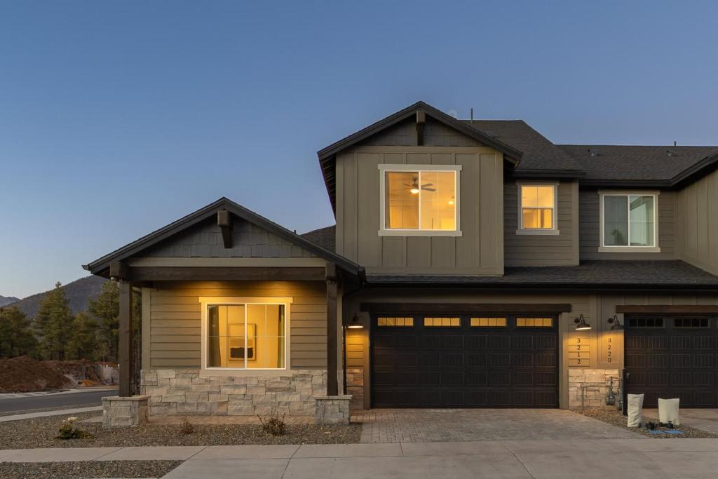 a house with a garage with its lights on at The Copperleaf Flagstaff Escape in Flagstaff