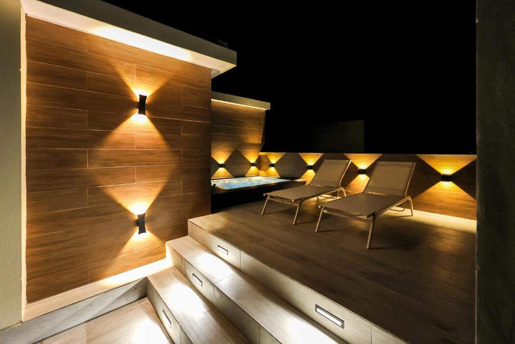 a room with two chairs and a bed with lights at 504 New, Fantastic Rooftop with Private Jacuzzi in La Laguna