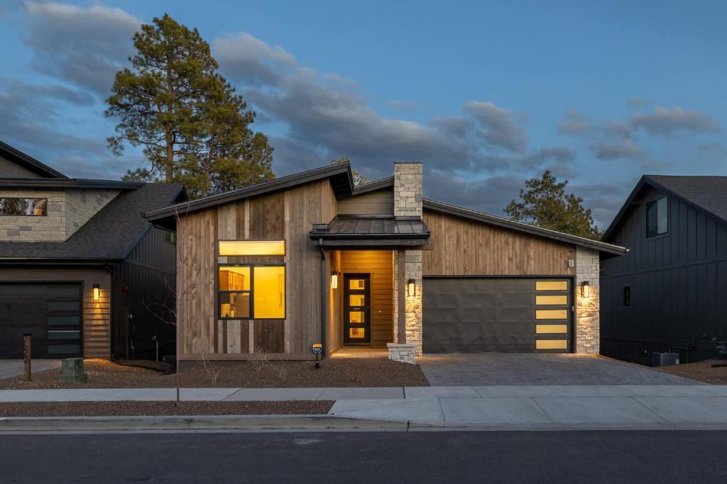 a wooden house with a garage at Home with Studio near Pine Canyon in Flagstaff