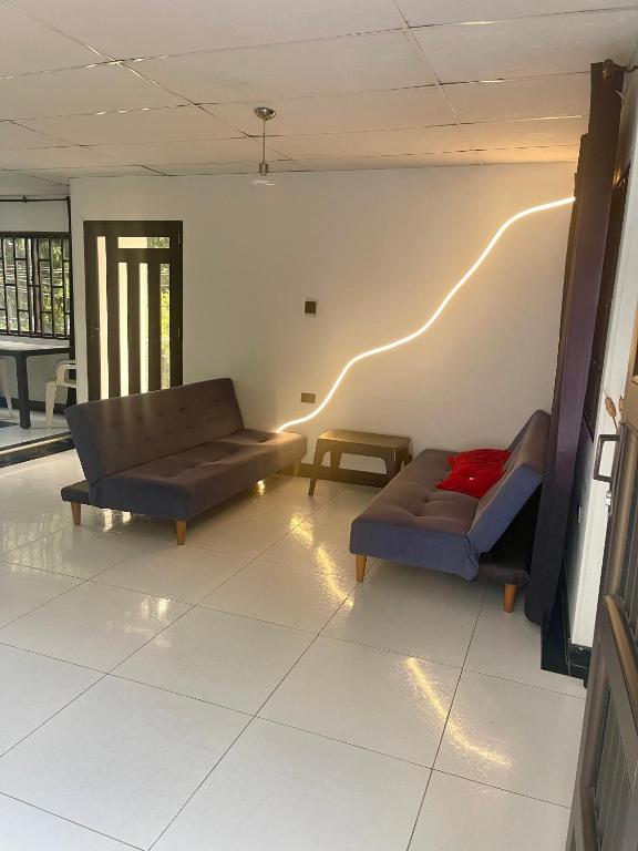a living room with two couches and a table at Apartamento EURARE in Ríohacha