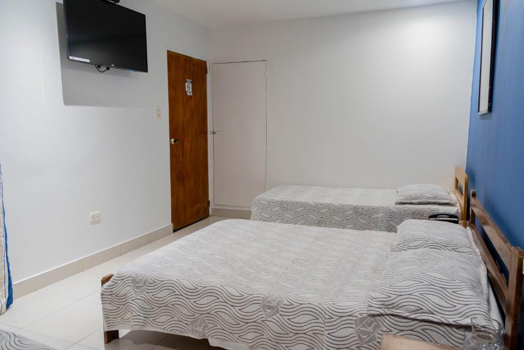 Postel nebo postele na pokoji v ubytování Hotel Veleros Cartagena