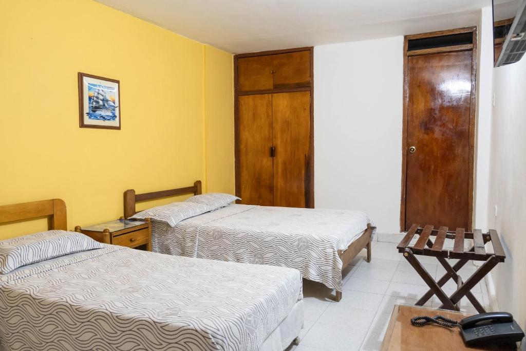 Postel nebo postele na pokoji v ubytování Hotel Veleros Cartagena