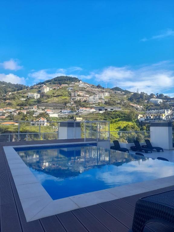 a swimming pool on the roof of a house at Art House Madeira I in Caniço