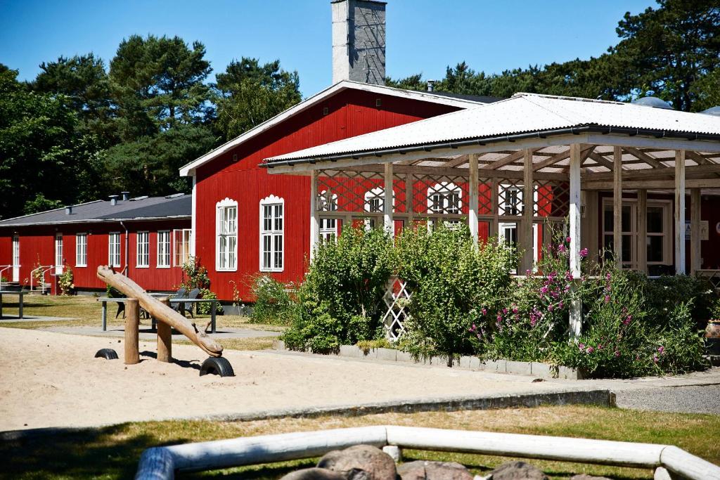 a red barn with a playground in front of it at Rønne Vandrerhjem in Rønne