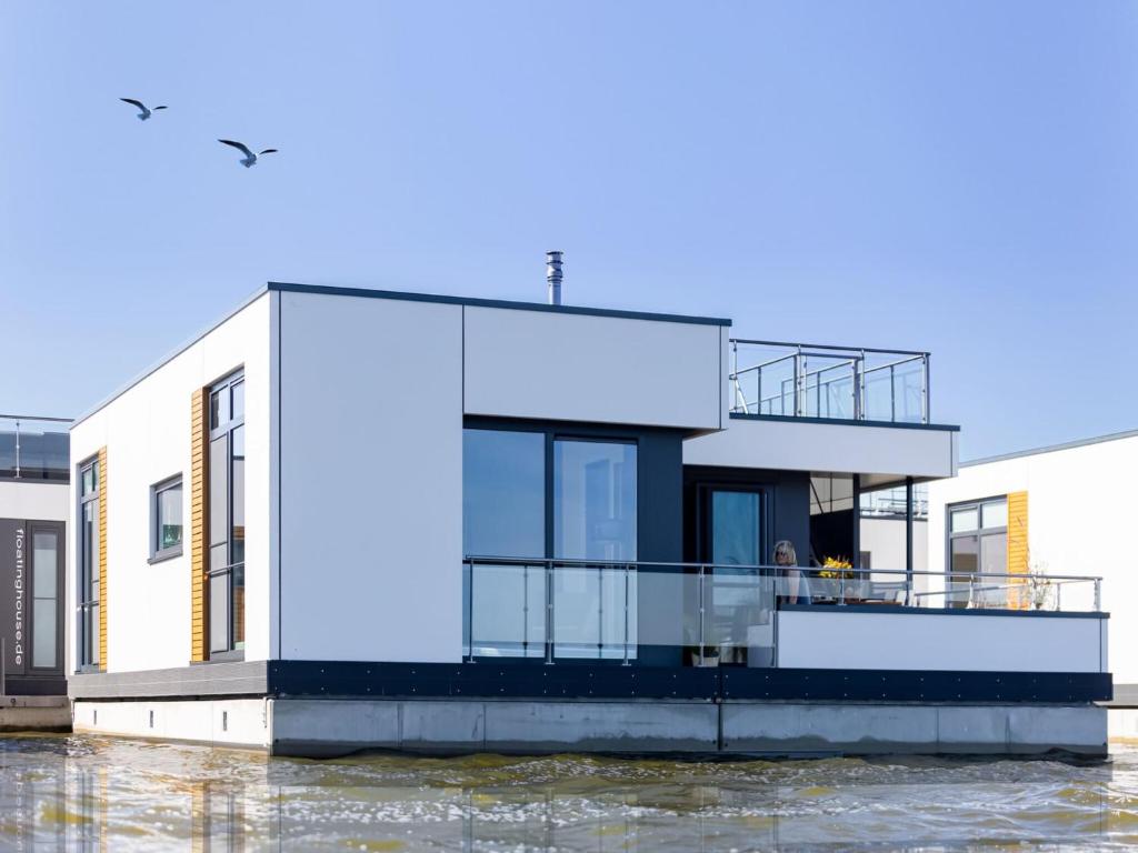 a house on a river with water at Coastal Comfort with Terrace in Ribnitz-Damgarten