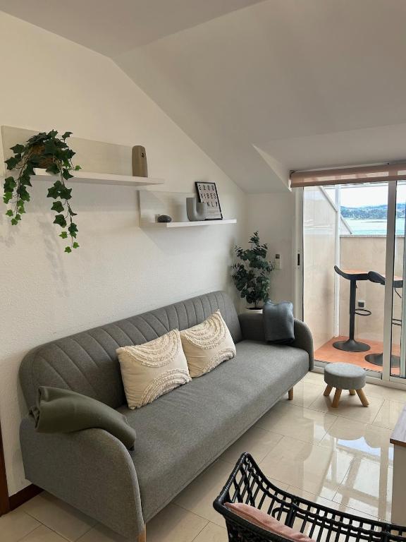 una sala de estar con un sofá y una mesa en Apartamento Aqua Marina, en O Grove