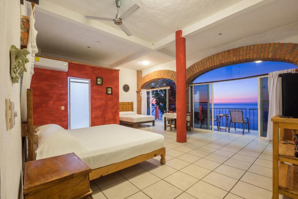 Postel nebo postele na pokoji v ubytování Traditional Sierra Leon Oceanfront Rooms - Adults Only