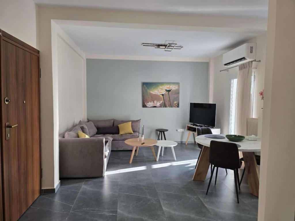 a living room with a couch and a table at Nektaria philoxenia place in Athens