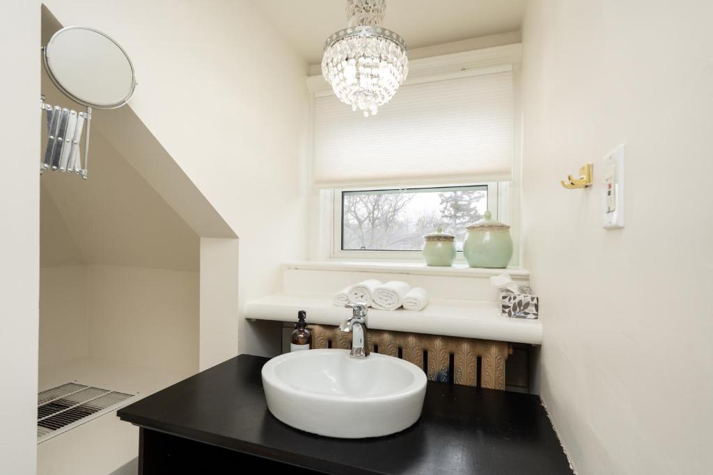 a bathroom with a sink and a chandelier at No. 5 East in Winnipeg