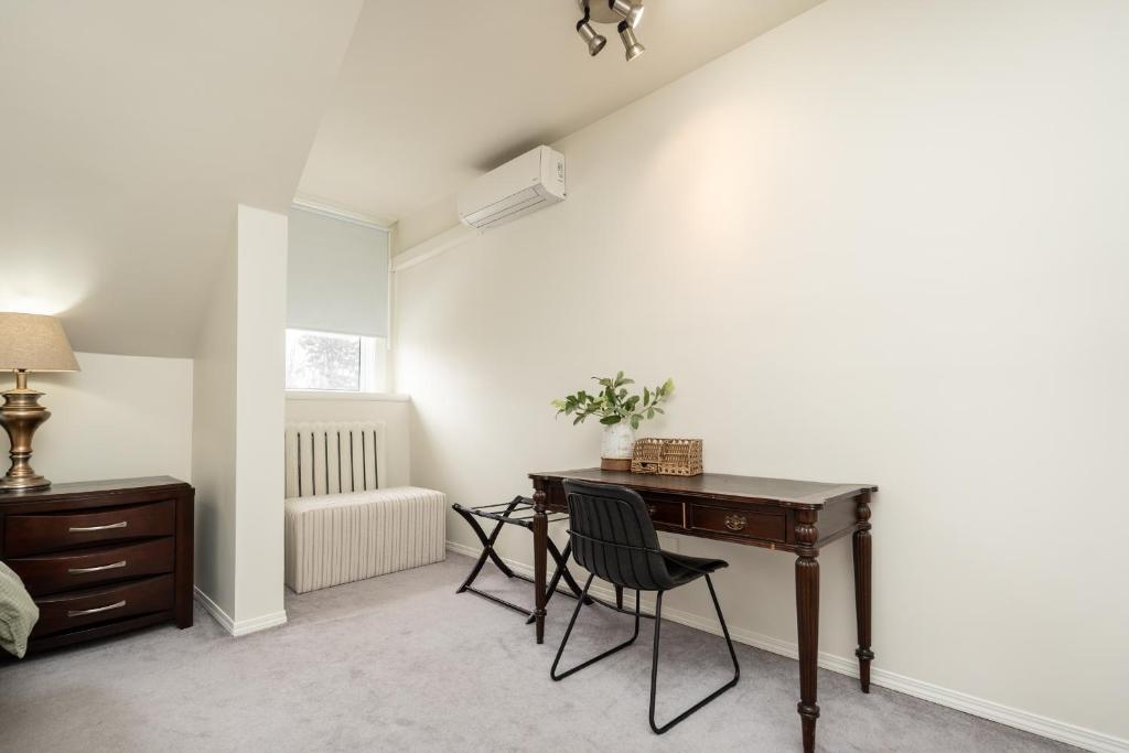 an office with a desk and a chair in a room at No. 5 East in Winnipeg