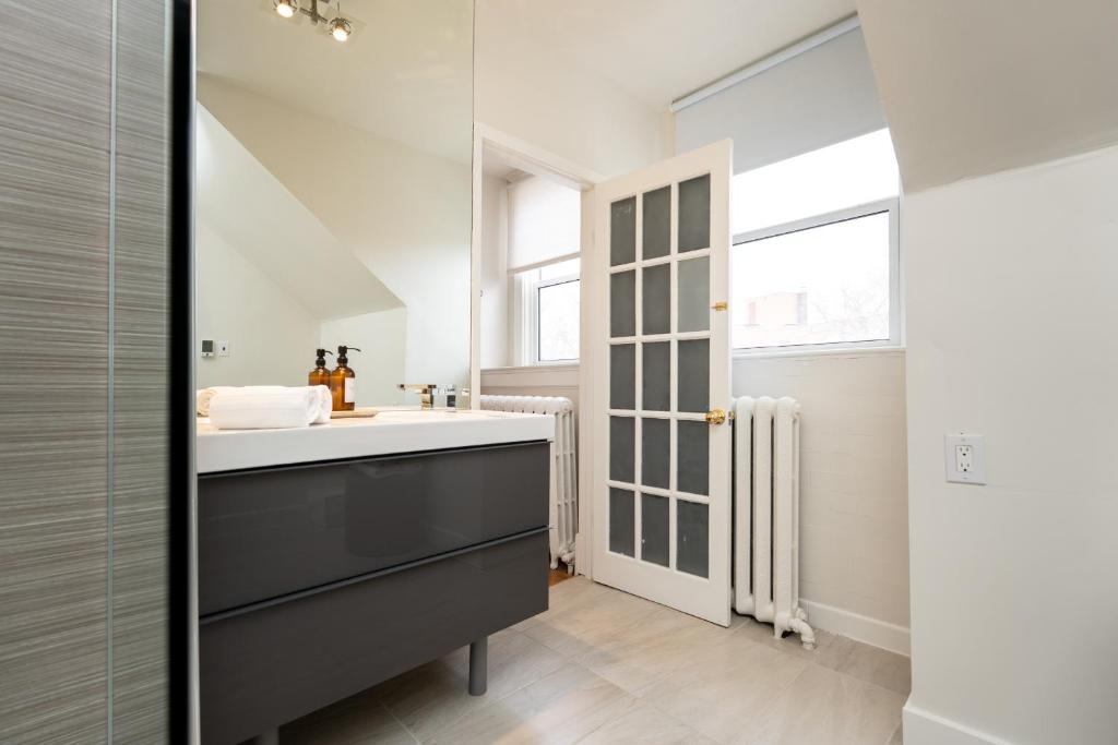a bathroom with a sink and a mirror at No. 5 East in Winnipeg
