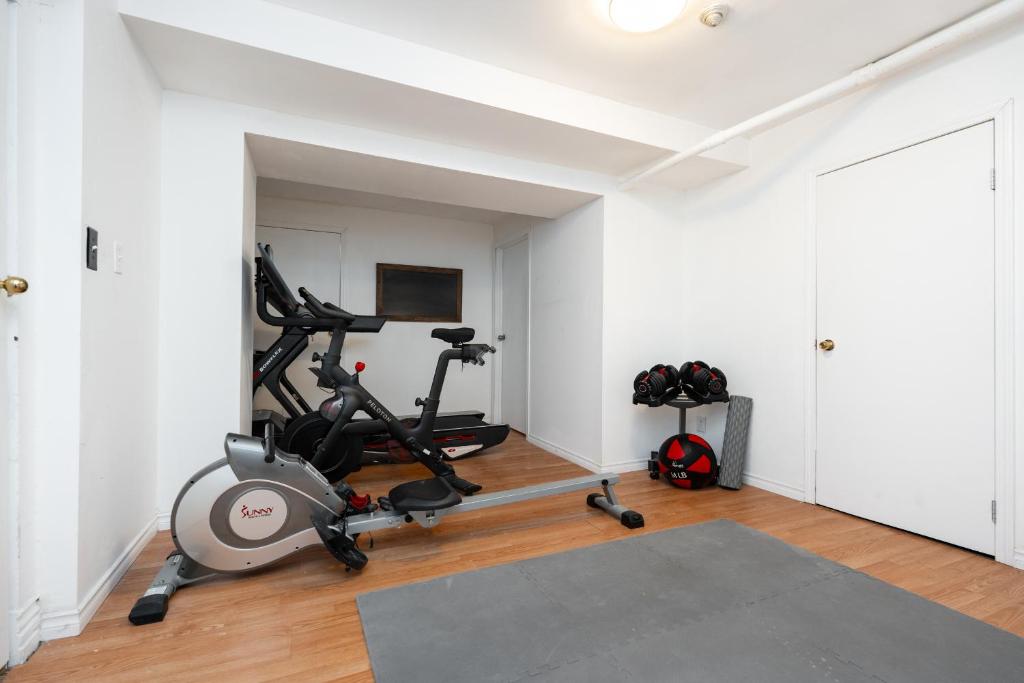 a gym with a treadmill and a exercise bike in a room at No. 5 East in Winnipeg