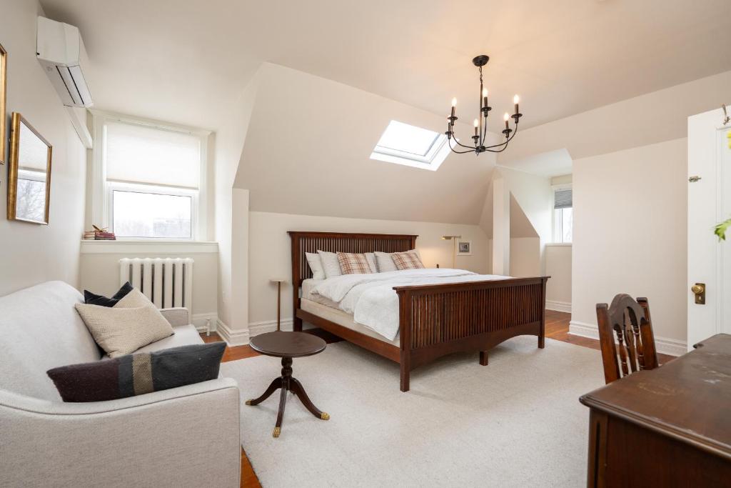 a bedroom with a bed and a couch at No. 5 East in Winnipeg