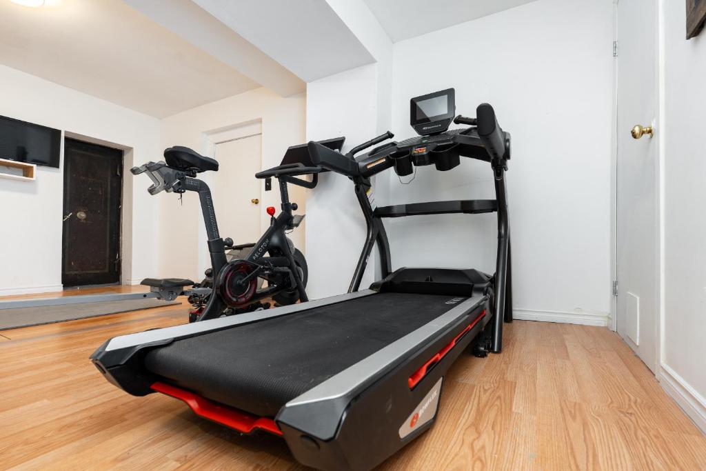 a gym with a treadmill in a room at No. 5 East in Winnipeg