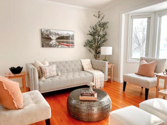 a living room with a couch and two chairs at Modern 3BR Near Airport & DT in Calgary