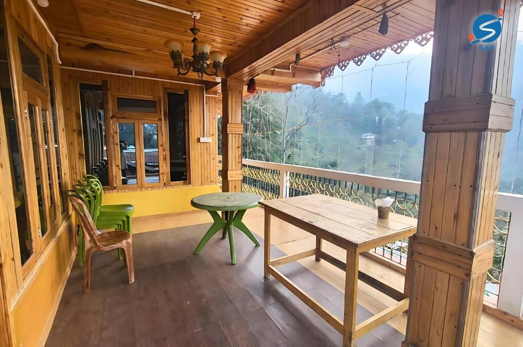 a room with a table and chairs on a balcony at Say Homes Glorious Holidays in Māngwa