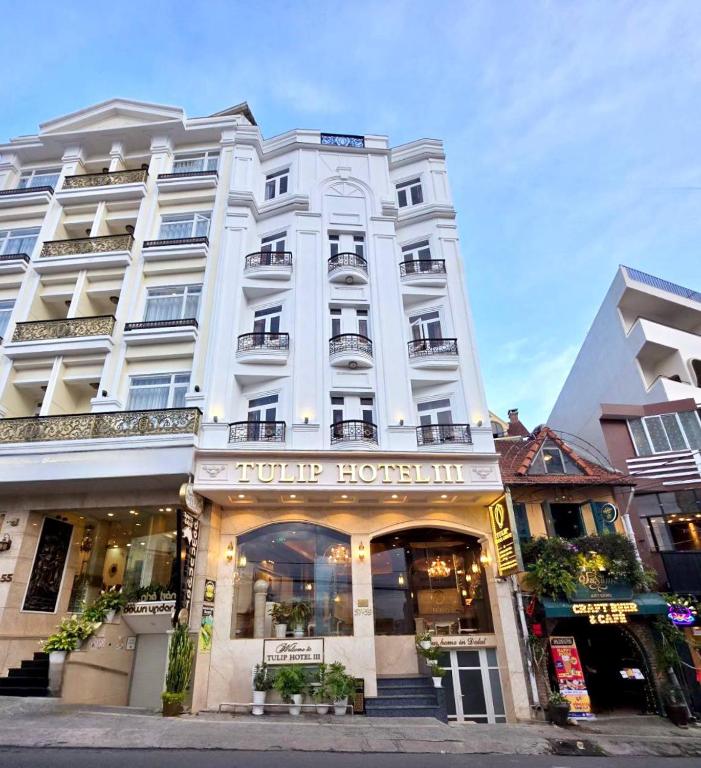 a large white building with a hotel at Tulip Hotel 3 in Da Lat
