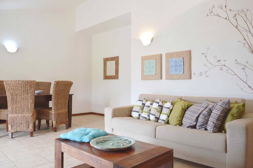 a living room with a couch and a table at Sa Tirìa in Chia