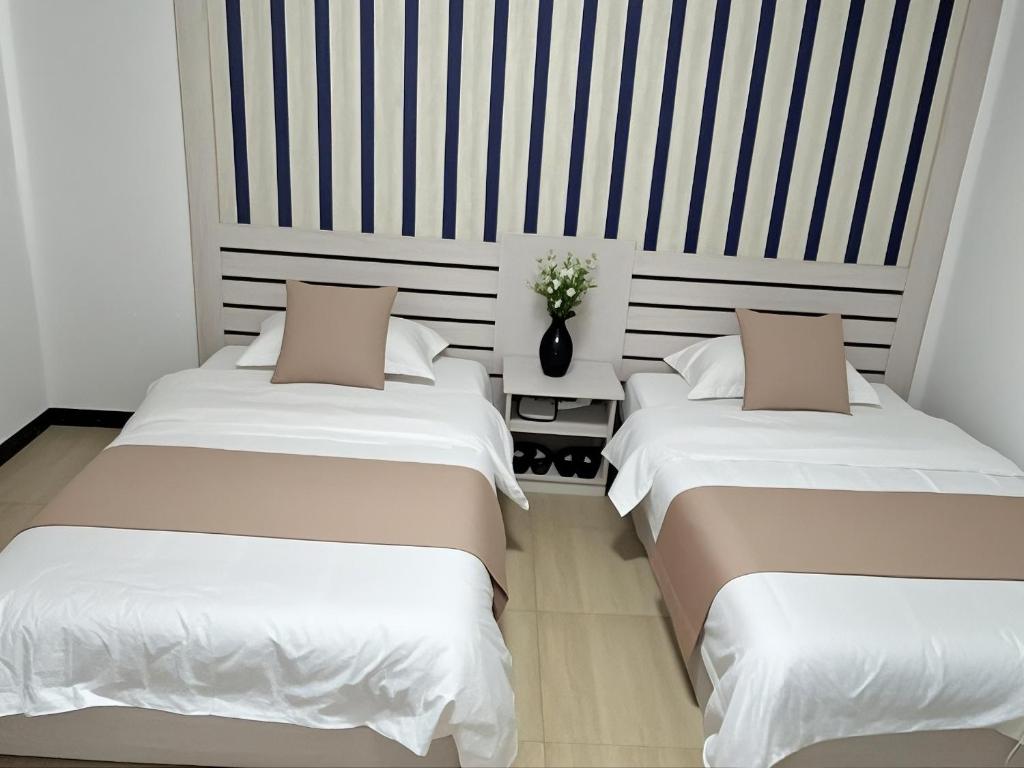 Postel nebo postele na pokoji v ubytování Junyao Inn