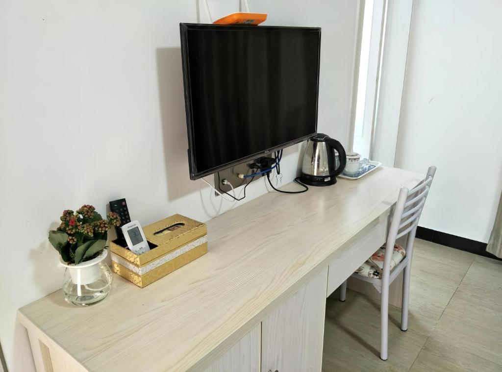 TV a/nebo společenská místnost v ubytování Junyao Inn