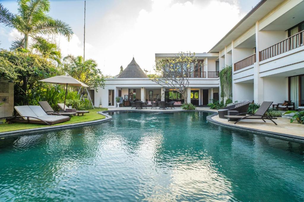a swimming pool in the middle of a building at Villa Diana Bali 14 Bedrooms in Seminyak