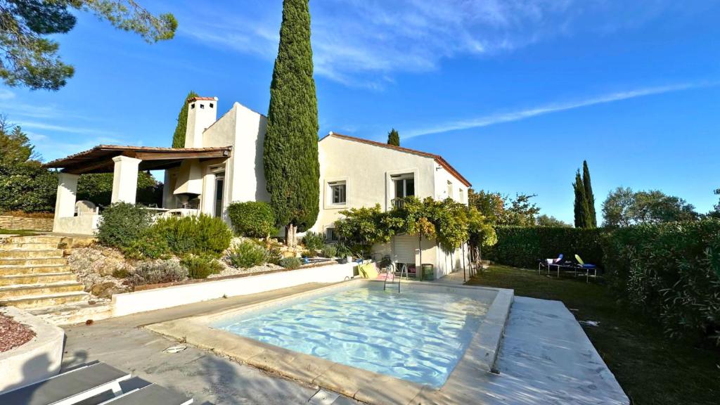 une maison avec une piscine dans la cour dans l'établissement La Villa du Thym, Spacieuse villa familiale, piscine et vue dégagée, à Saint-Gély-du-Fesc